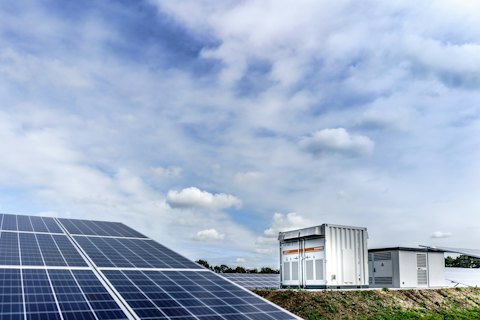 Solar panels next to a battery storage system