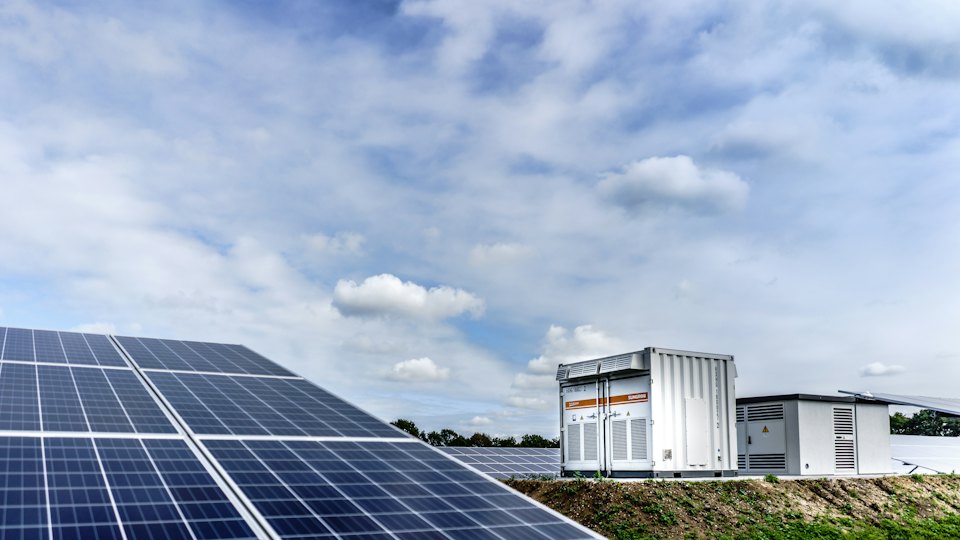 Solar panels next to a battery storage system